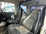 two seats in the back of a truck that is empty
