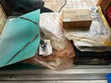 a pile of boxes and bags sitting on a shelf