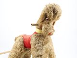 a stuffed dog that is wearing a red shirt