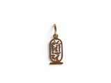 a small gold egyptian hierole charm with an inscription on it