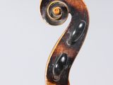 a close up of a violin neck with a spiral design on it