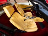 a red car with yellow leather seats in the back of it