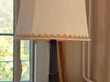 a lamp that is on a table in front of a window