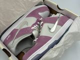 purple and white nike sneakers in a box on a table