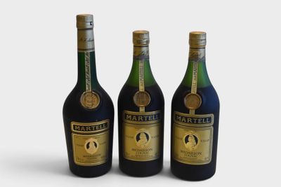 three bottles of wine sitting next to each other on a white surface
