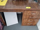 a wooden desk with a clock on top of it