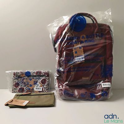 un sac et un portefeuille posés l'un à côté de l'autre sur une table