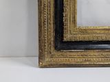a black and gold picture frame on a white background
