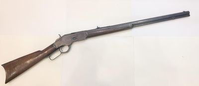 a rifle with a wooden barrel and a wooden handle