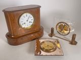 a small wooden clock sitting next to a small clock on a table
