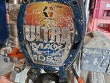 a small blue motorcycle with a sign on the back