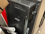 a computer monitor sitting on top of a desk next to a box