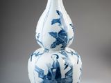 a blue and white vase sitting on top of a table