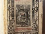 un vieux livre sur lequel figure l'image d'un homme assis à un bureau