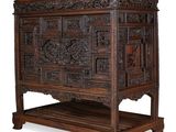 an old wooden chest with carved panels on top of it