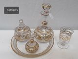 a glass tray with a glass decanter and a glass cup on it