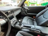 the interior of a car with black leather seats and steering controls