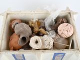 a box with a bunch of clay objects inside of it