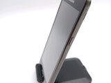 a cell phone that is sitting on top of a stand