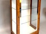 a small display case with glass shelves in it