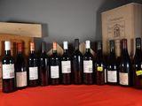 several bottles of red wine are lined up on a table