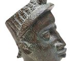 an image of a statue of a man with a bird on top of his head