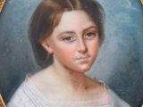 portrait of a young girl in a white dress in a gold frame