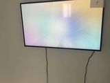 a flat screen tv mounted on the wall in a room
