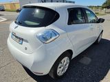 a small white car parked in a parking lot
