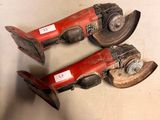 pair of red and black pipe cutters sitting on top of a white surface