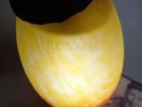 a close up of a banana with a black hat on it
