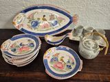 many plates and cups on a table with a basket