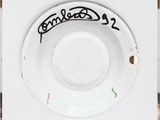 a close up of a white plate with a black writing on it
