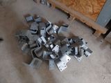 a pile of metal parts on the floor in a room