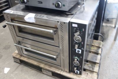 a stack of ovens sitting on a pallet in a warehouse