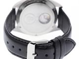 black leather strap on a watch with a white face