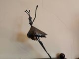 a statue of a bird on a table next to a tv