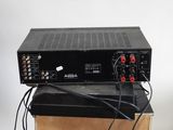 a close up of a black amplifier sitting on top of a wooden box