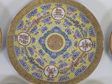 several plates with chinese writing are arranged on a white surface