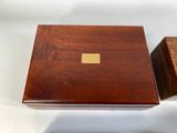 a wooden box with a brass plate on it