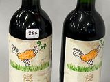 two bottles of wine sitting next to each other on a table