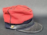 un chapeau rouge orné d'un ruban noir