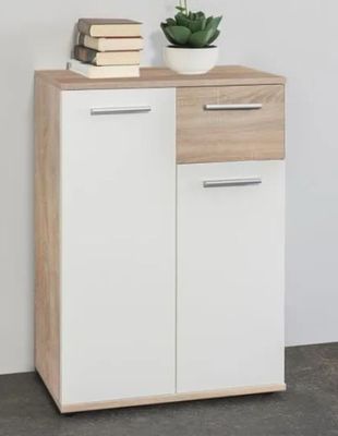 a close up of a white cabinet with a plant on top of it