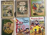plusieurs livres pour enfants sont alignés sur une surface blanche