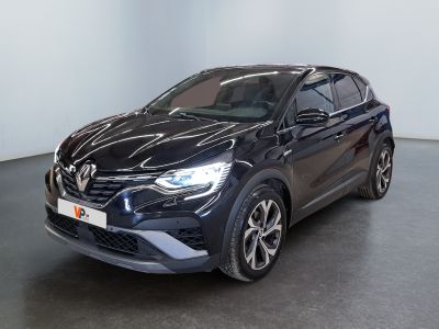 a black car parked in a room with a white wall