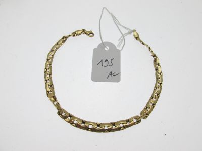 gros plan d'un bracelet en or portant une étiquette de prix