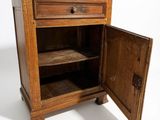 a small wooden cabinet with a door open on a white background