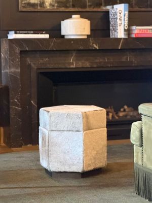 two chairs in front of a fireplace in a living room