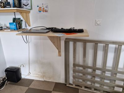 a desk with a keyboard and a monitor on it