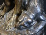 a bronze statue of a boy and a dog on a pedestal